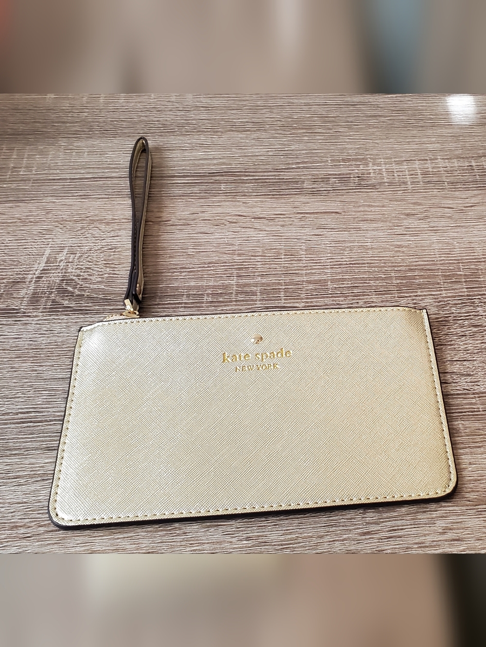 kate spade gold wristlet pouch with black/gold strap